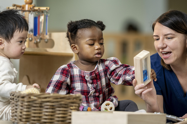 Children playing with childcare practitioner
